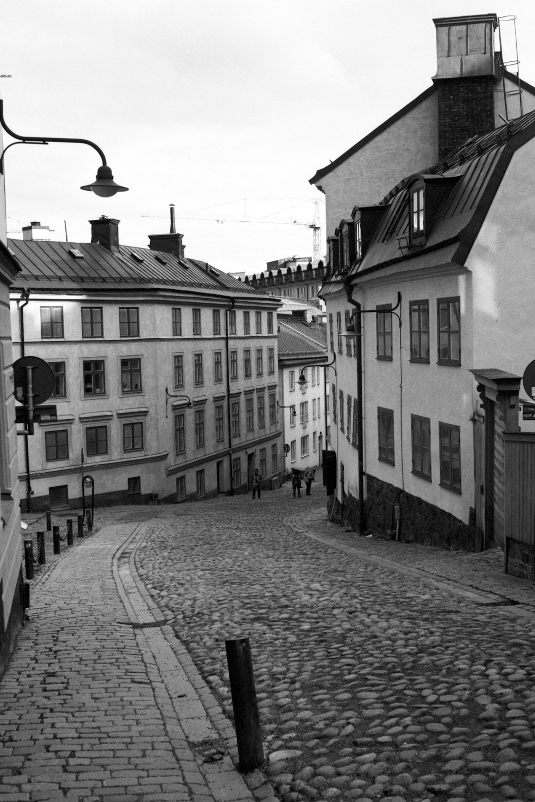 Black and white photo of a narrow cobblestone alley in a Danish old town