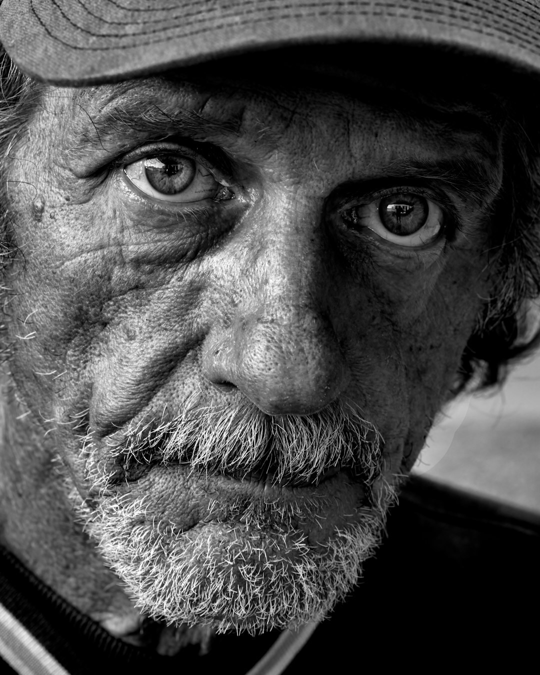 Portrait of an elderly Danish fisherman with weathered face standing on a harbor